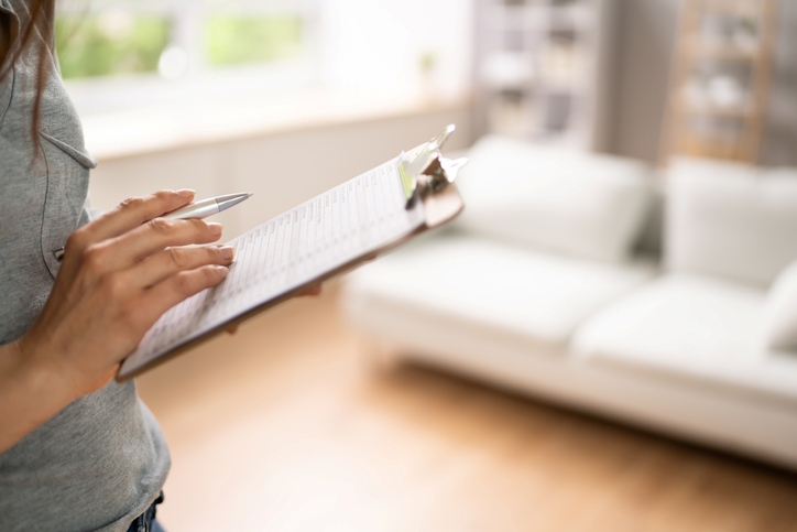 An inspector conducts a pest control analysis of a rental property.
