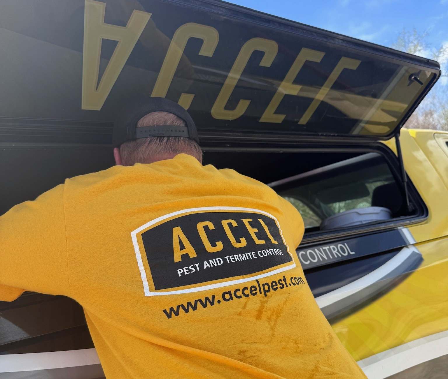 An Accel Pest and Termite control team member retrieves equipment from our vehicle before a treatment.